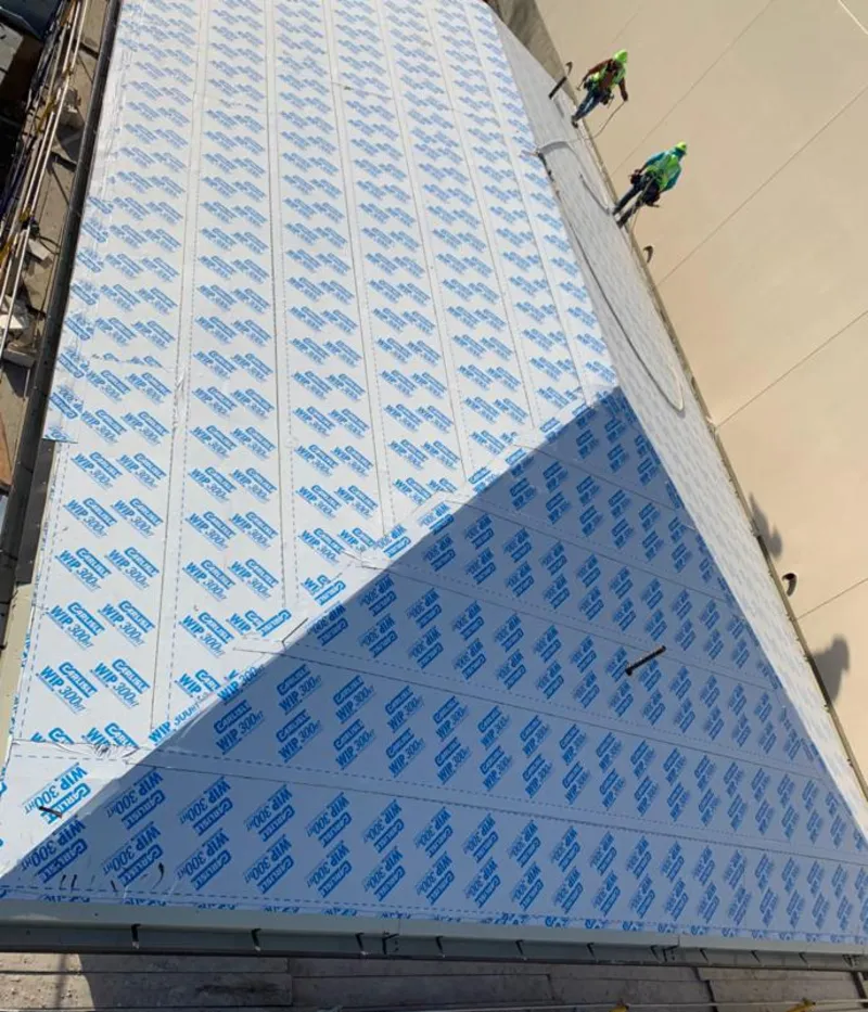 Professional roofers installing underlayment on a metal roof in Fort Meade